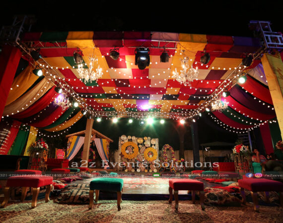 grand setup, colorful wedding, trussing with colorful fabric draping